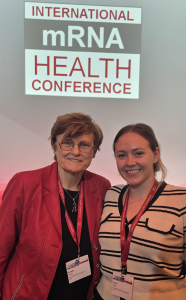 Image of Graduate Student Jamie Jones meeting with Prof Katalin Kariko at the mRNA Health Conference in Berlin.